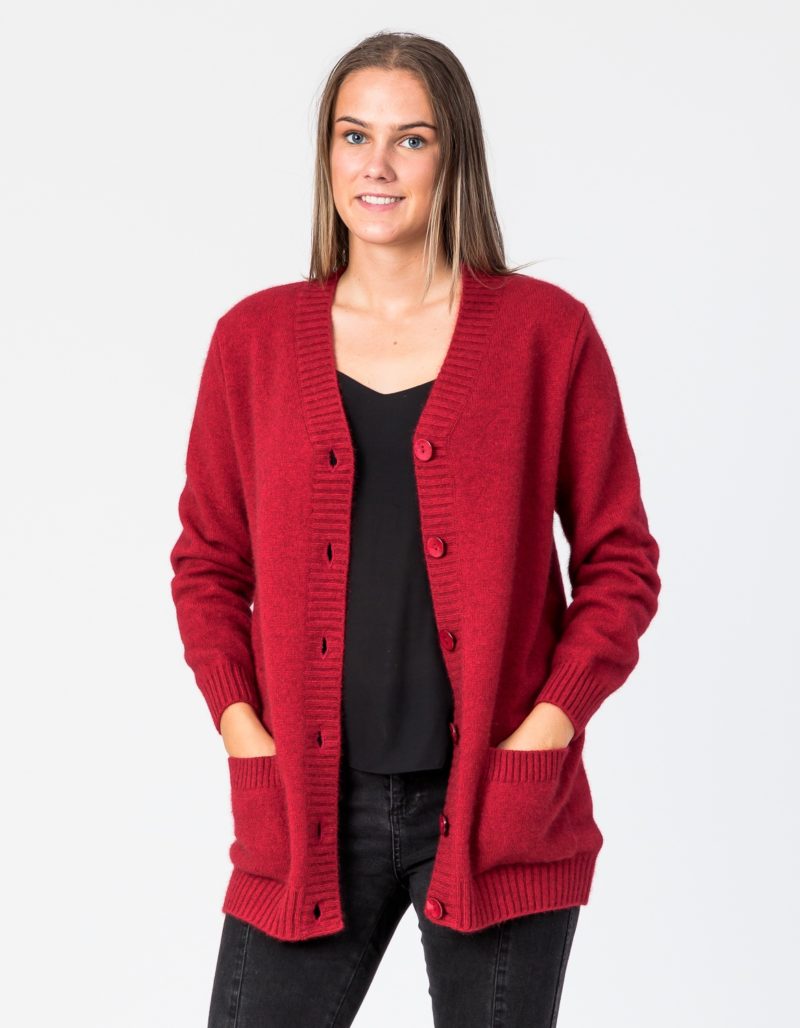 Georgia Possum Merino Cardigan with oversized rib trim, twin pockets and shell buttons, pictured here in red